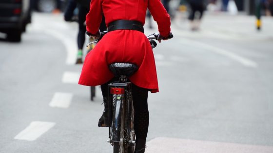 Woman with red jacket cycling