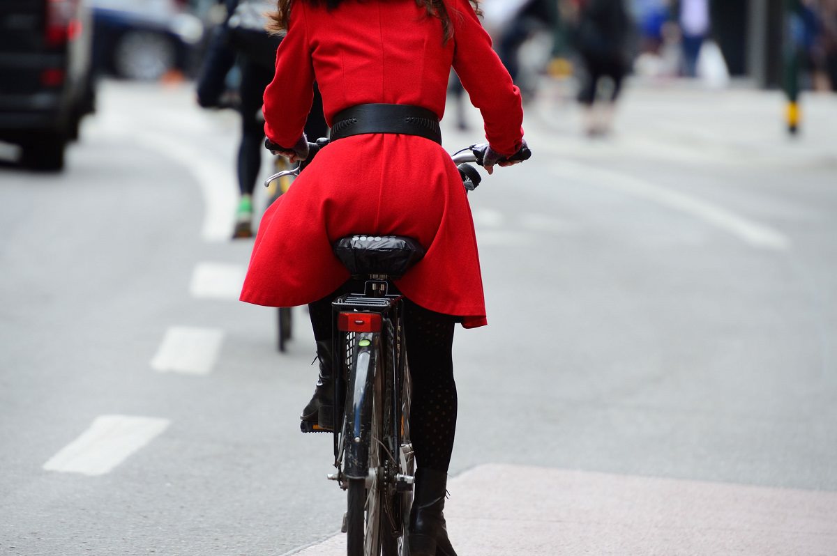 Woman with red jacket cycling