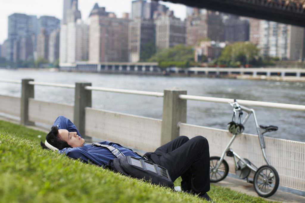 Man relaxing next to folding bike