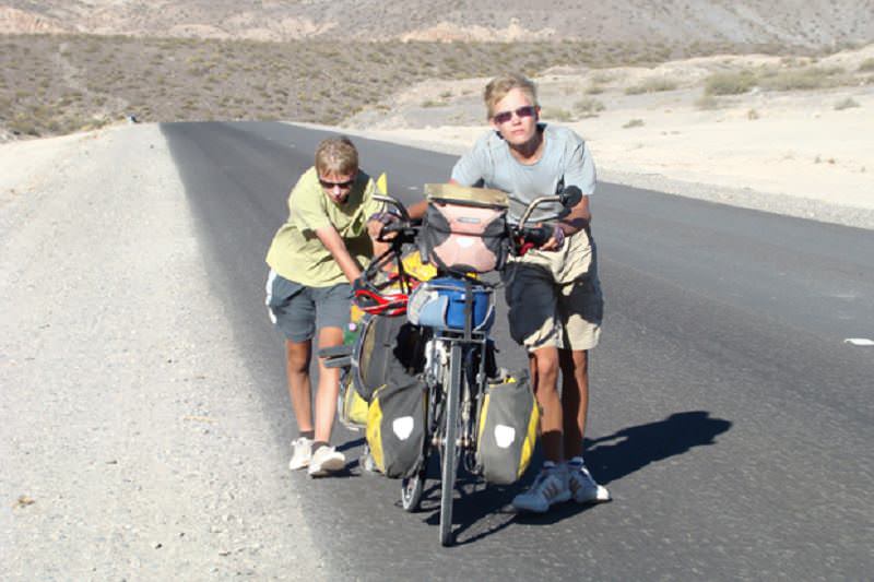 Tired boys with bike