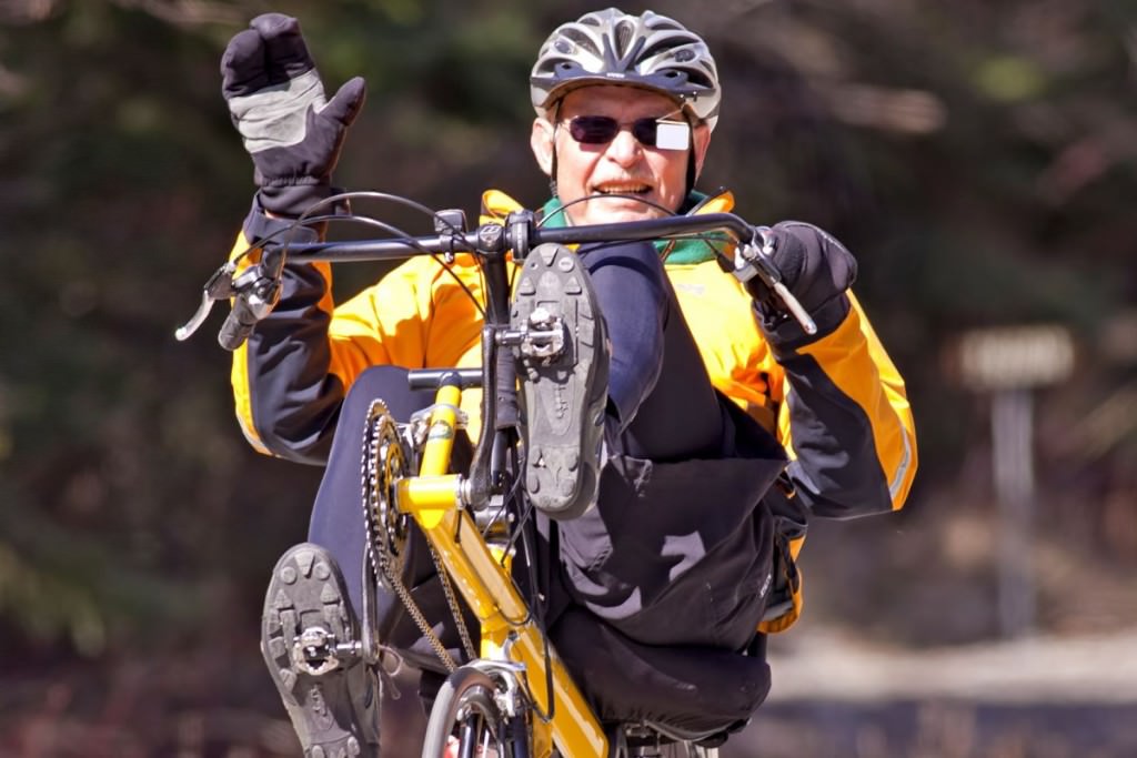 Recumbent rider waving