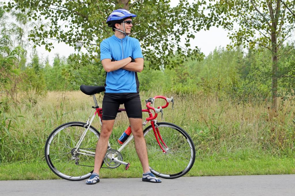 Man standing with road bike