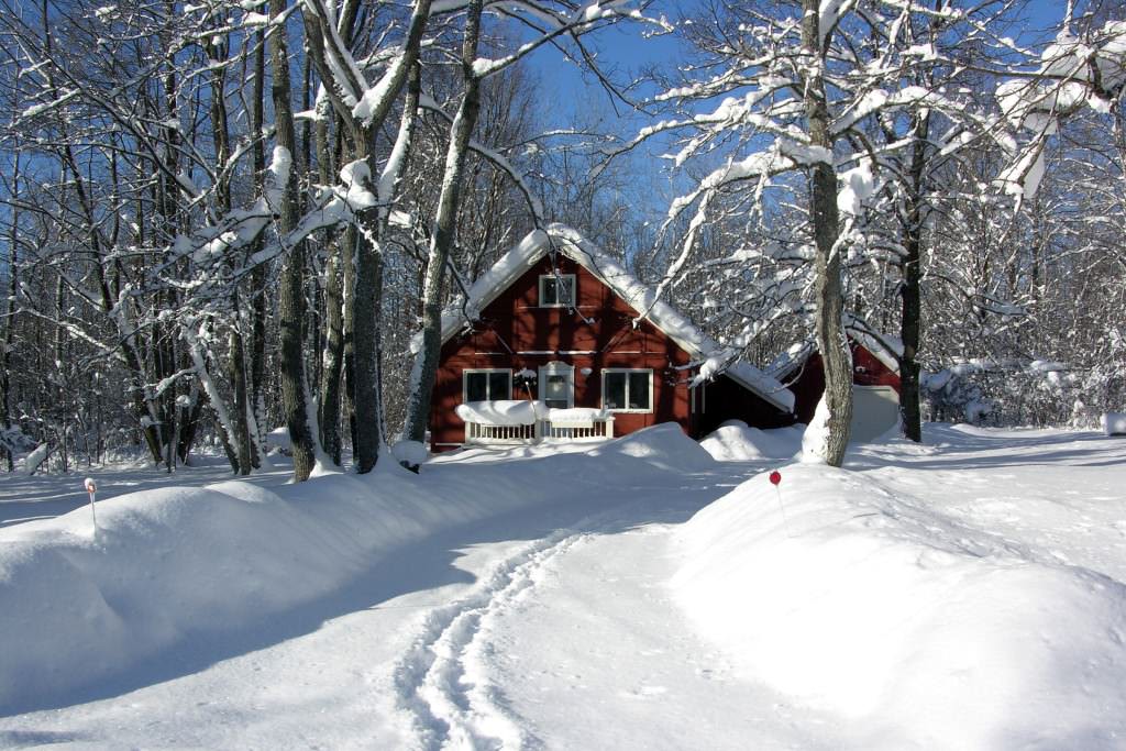 Cottage with snow tracks