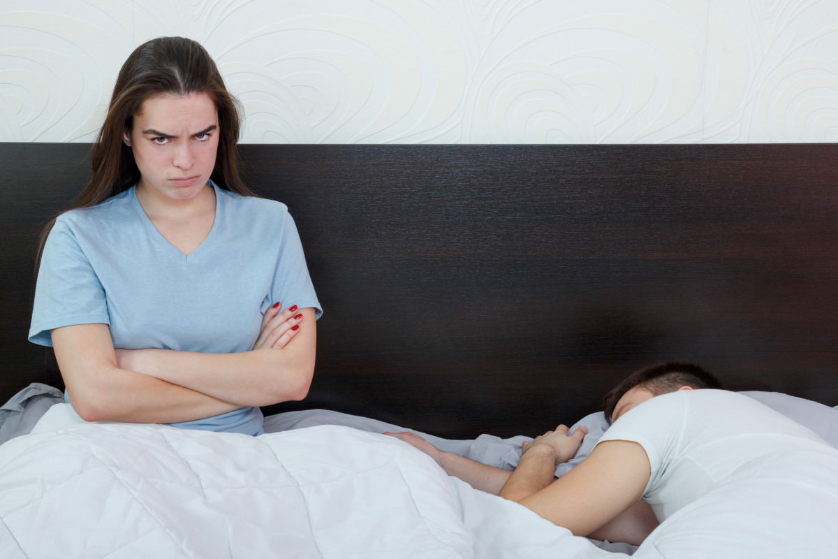 Dissatisfied woman on bed