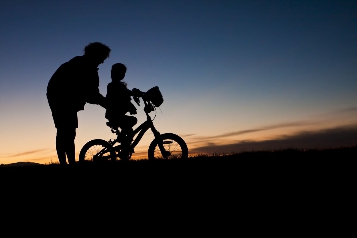 Child learning to ride a bicycle