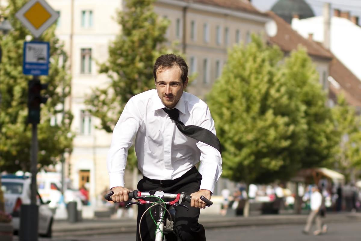 Business man riding bike in the city