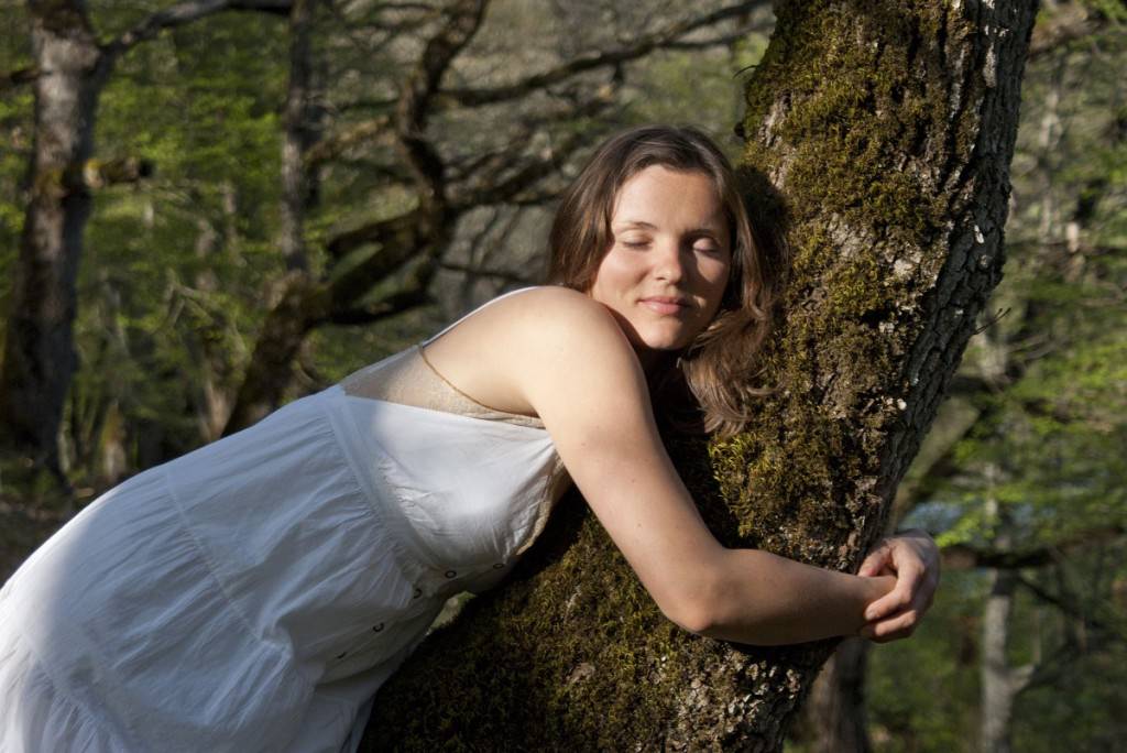 Woman hugging a tree