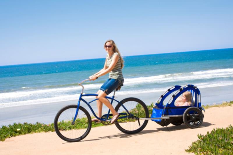 Family bicycle ride along the beach