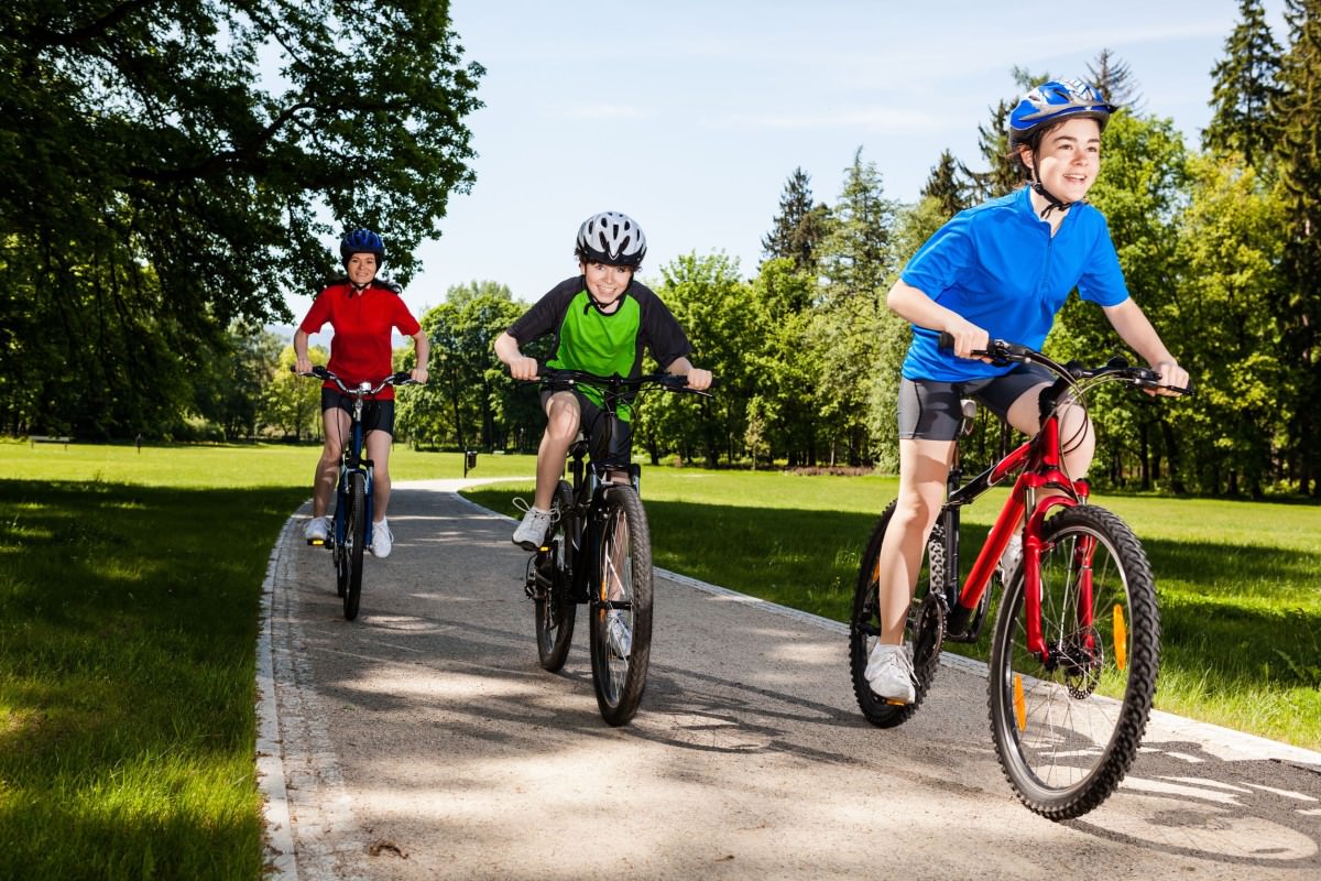 Children cycling in park