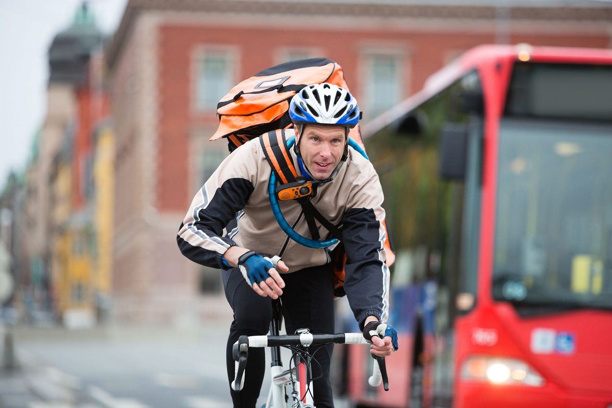 Man cycling with courier delivery bag