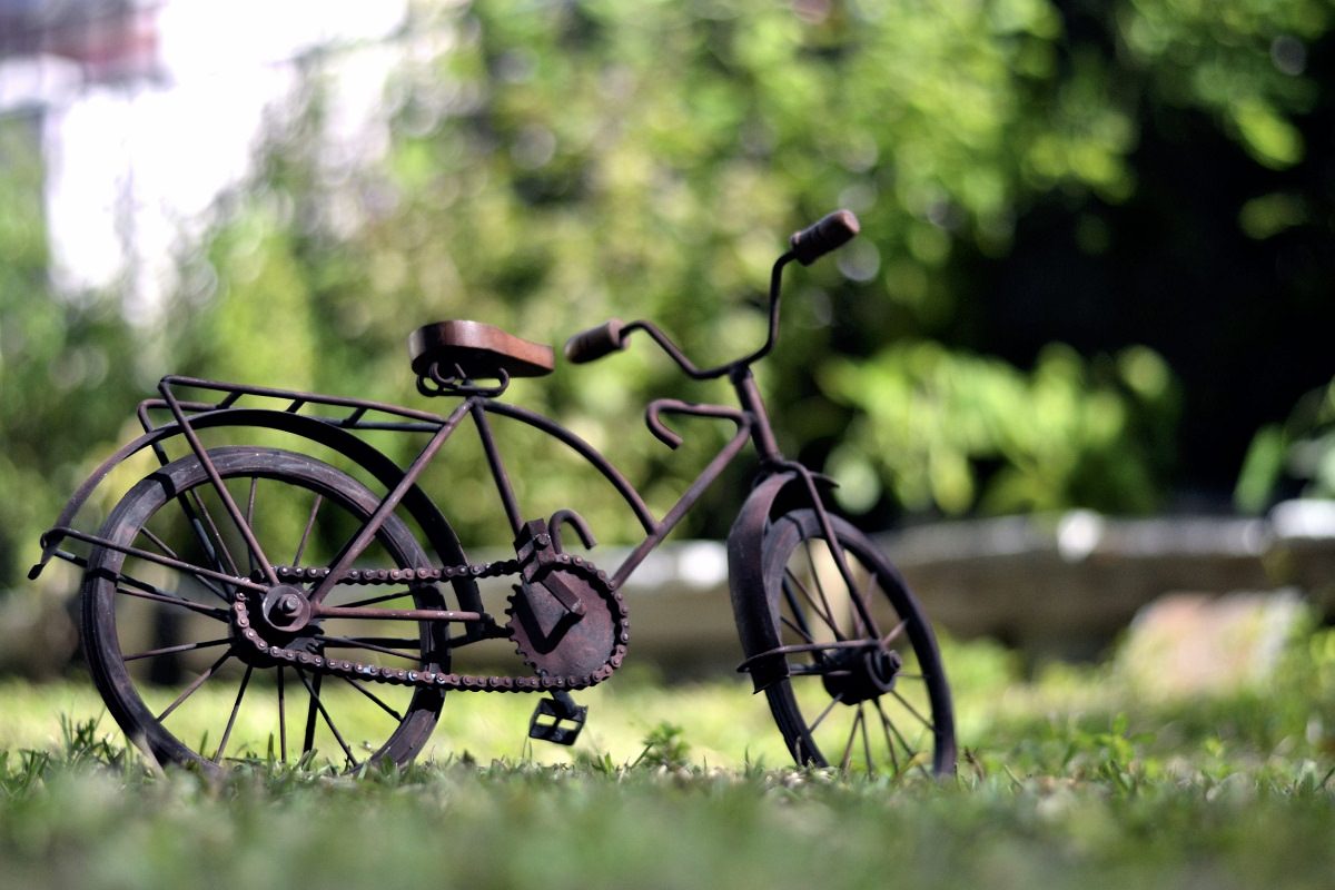 Old bicycle parked in a field