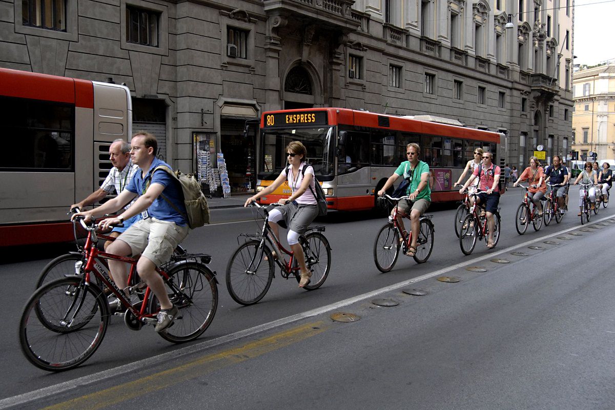 Tourists cycling in city streets