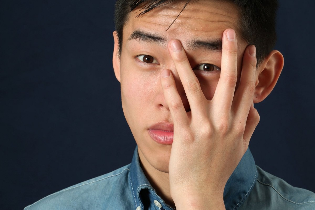 Man with palm on face