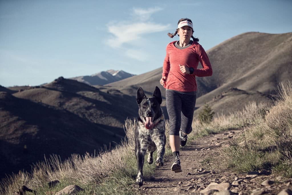 Rebecca Rusch running with her dog