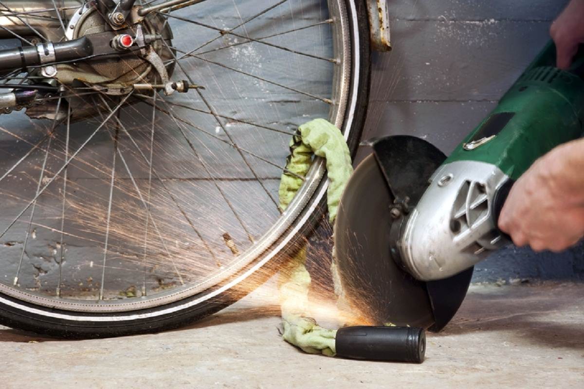 Thief cutting a bike lock with cutter