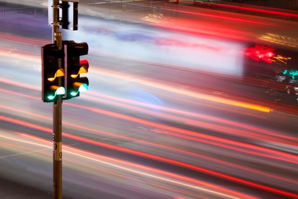 Fast traffic passing a traffic light