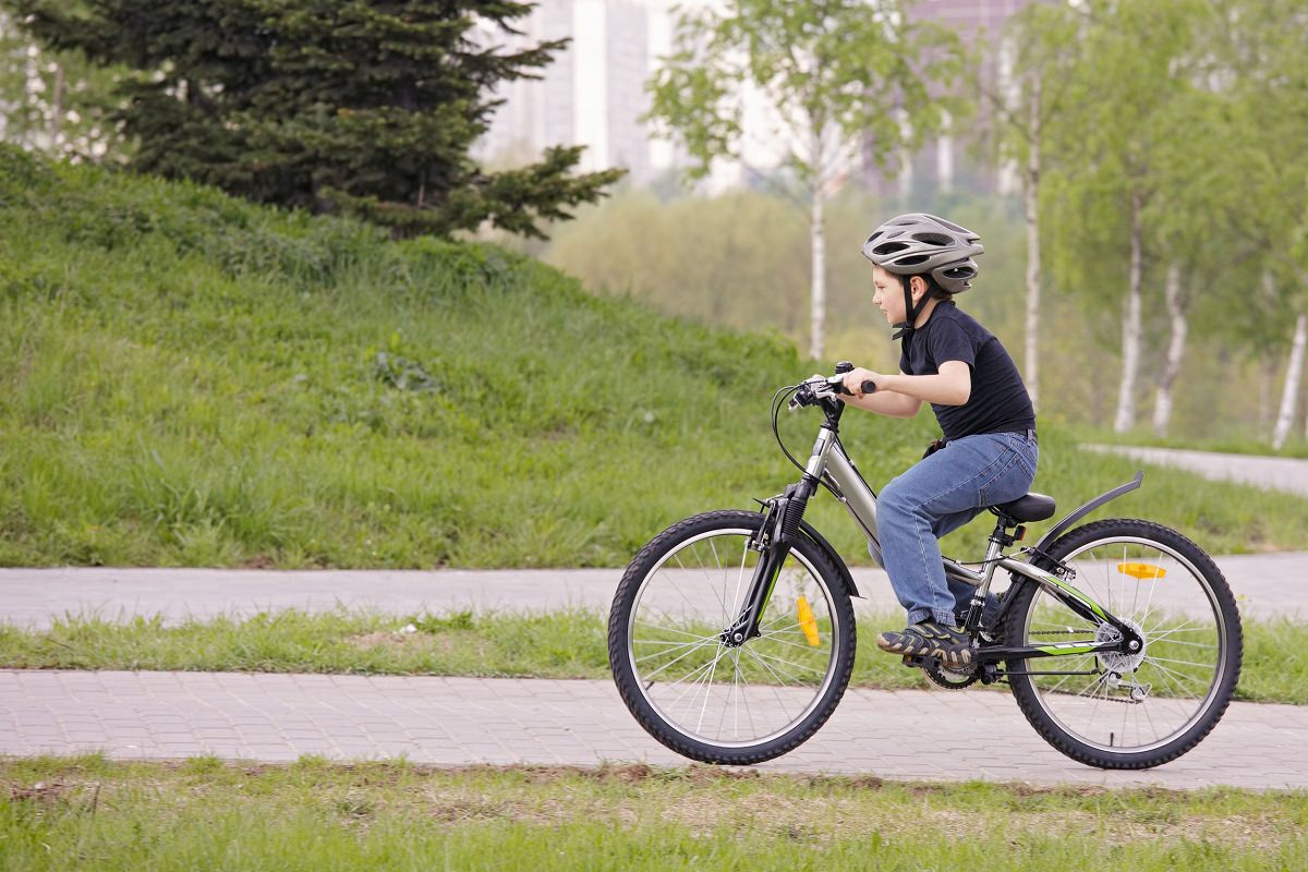 Boy cycling on a bike lane