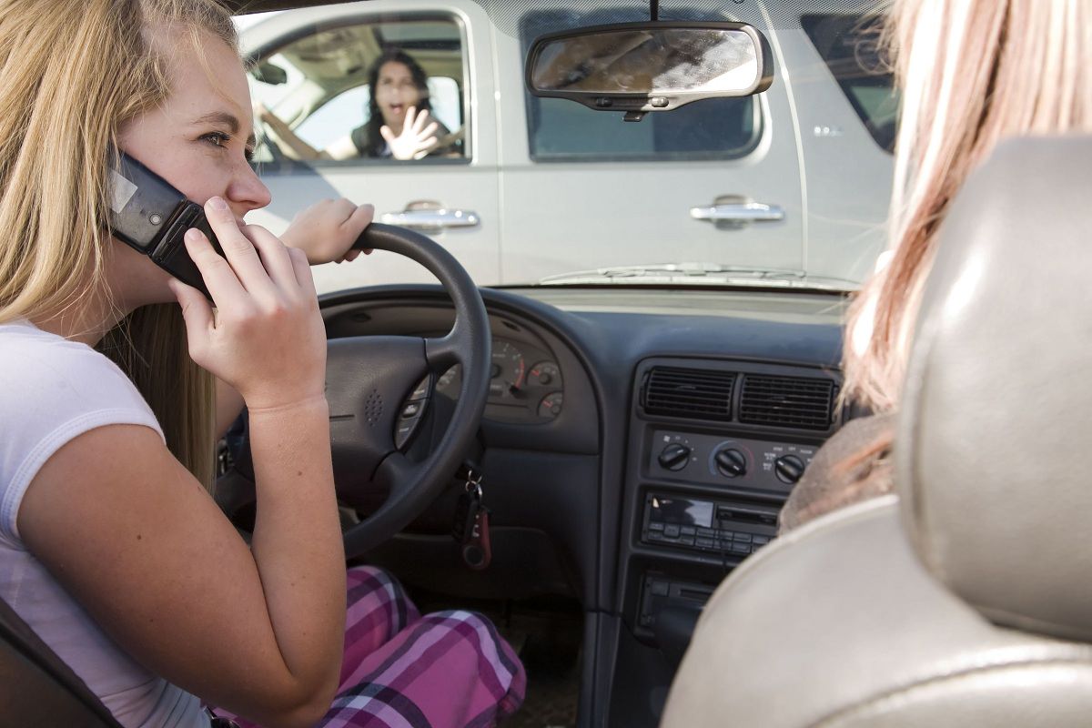 Teenagers on the phone while driving