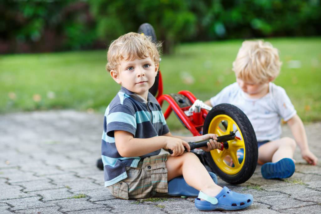 Toddler repairing his balance bike