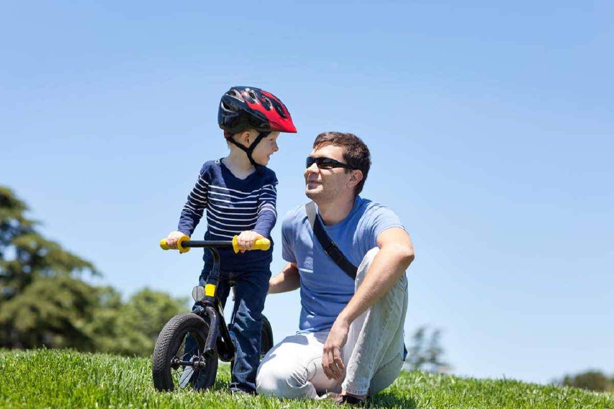 Father and son with a balance bike