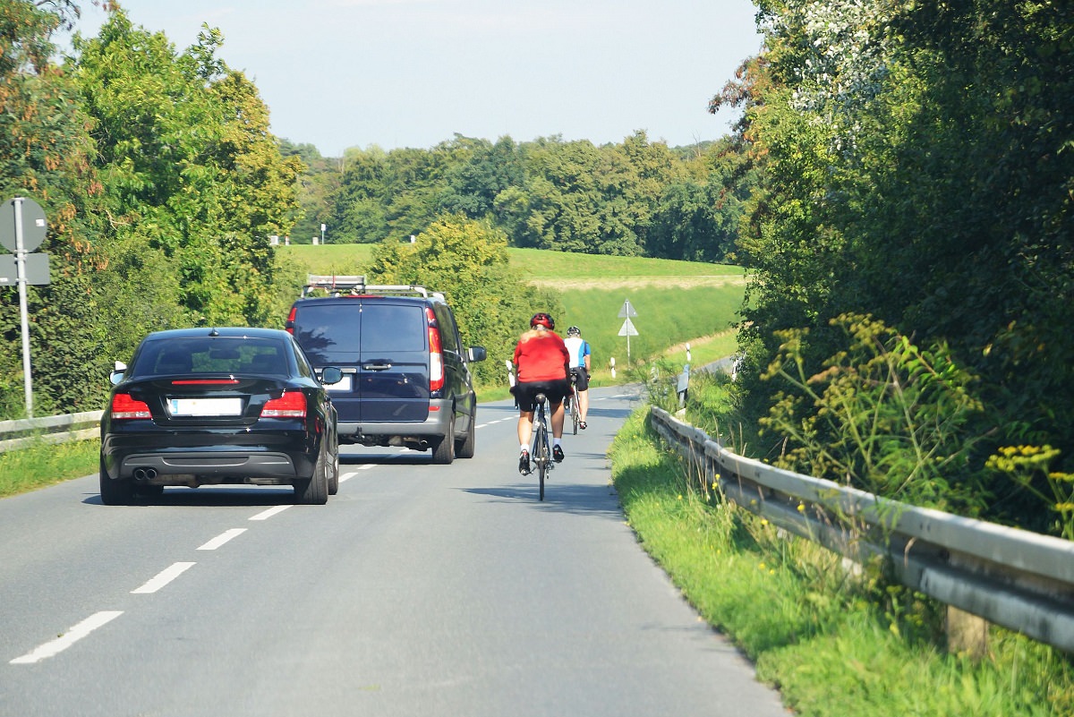 Cyclist passed by cars