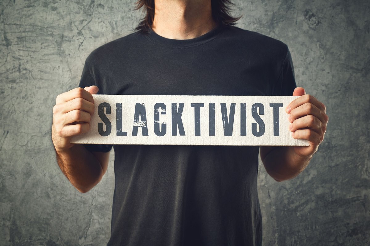 Man holding SLACKTIVIST sign