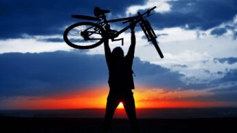 Man holding his bike high