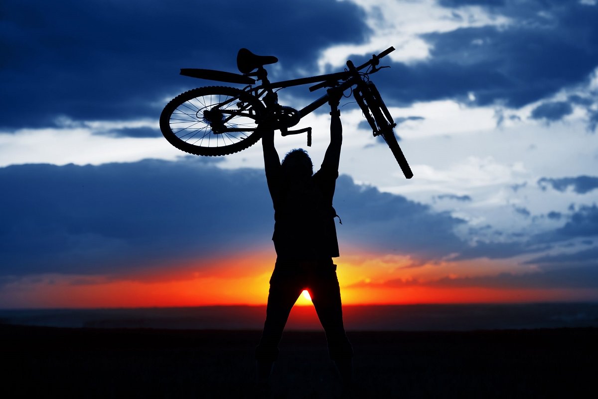 Man holding his bike high