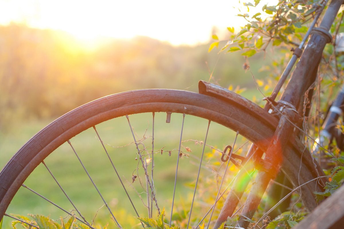 Old bicycle against sunset