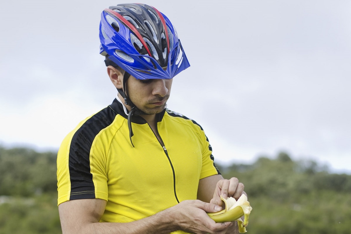 Road biker eating a banana