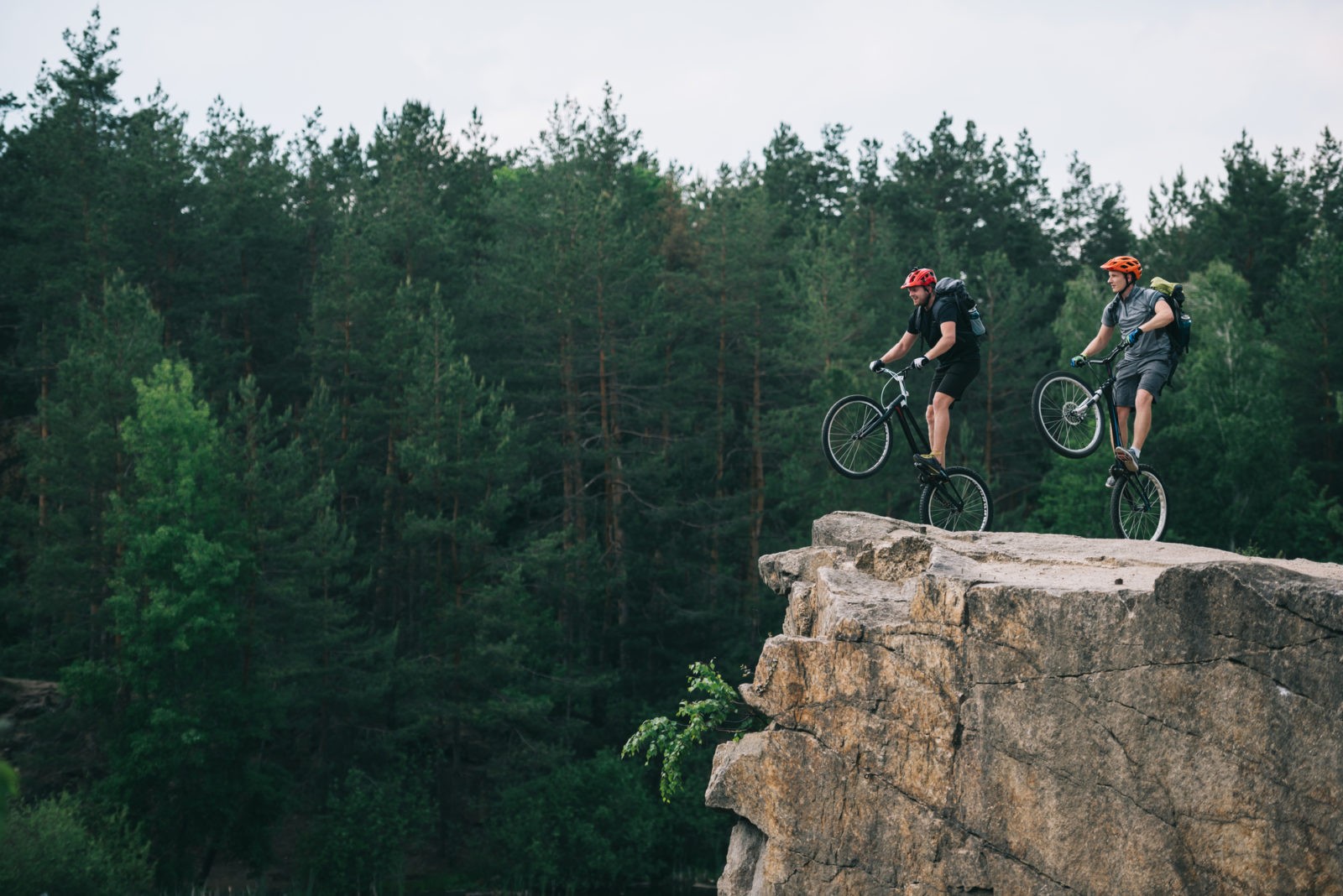 Bikers cycling with backpacks in the nature