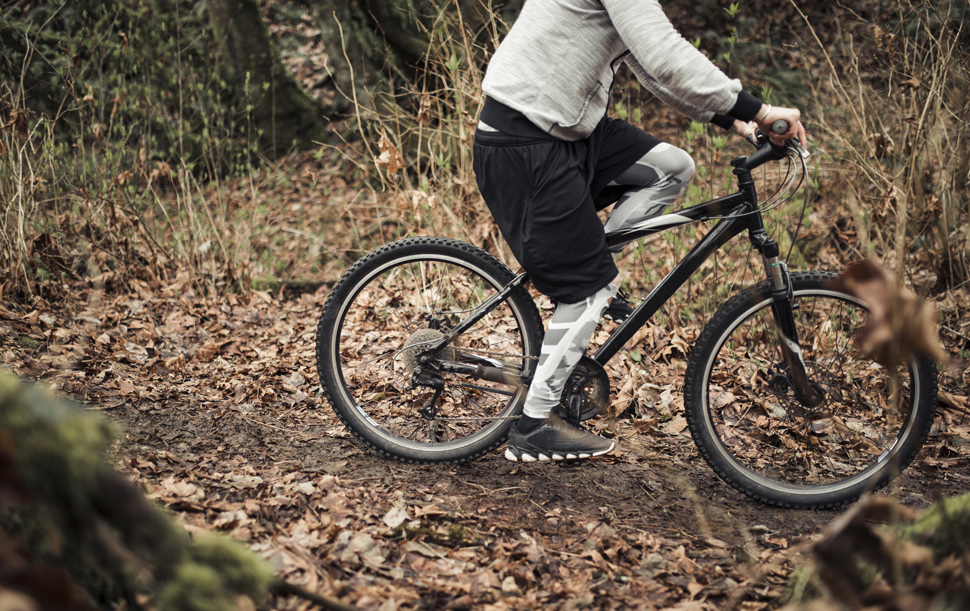 Cyclist riding bicycle on trail