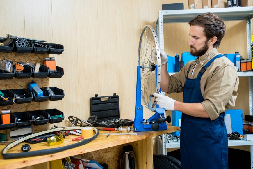 Mechanic tightening the spoke tension