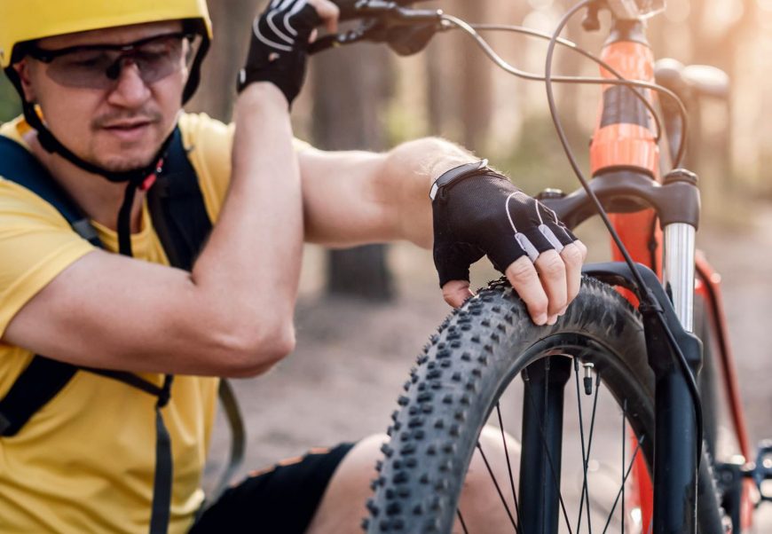 Cyclist Checking Wheel Pressure