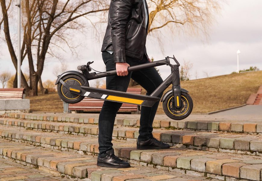 Man Carries Electrical Kick Scooter