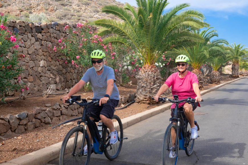 Senior Couple Riding Electric Bicycle