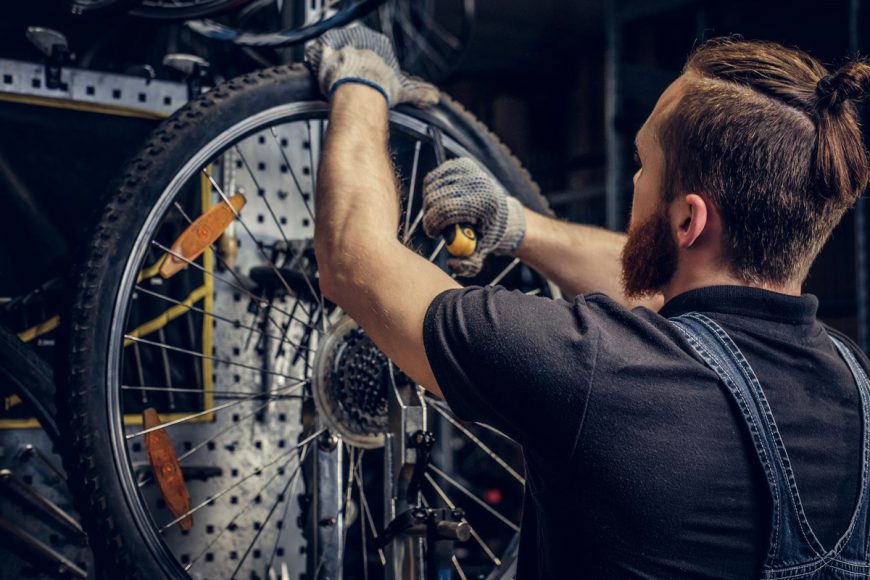 Mechanic Repairing Bicycle Wheel