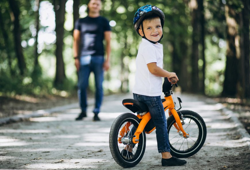 Father Teaching Son To Ride Bike