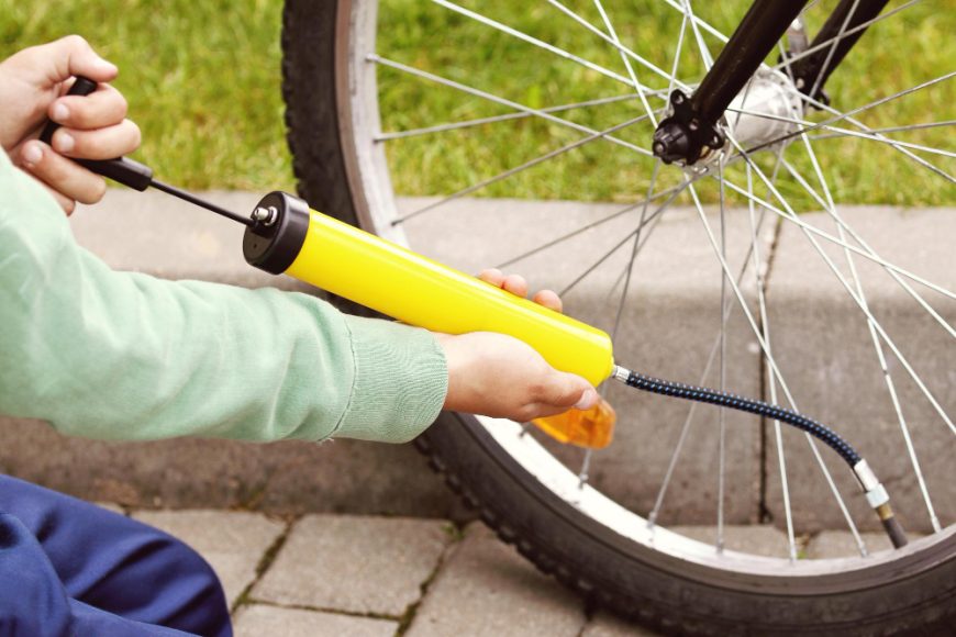 Cyclist Hands Pumping Bicycle Tire