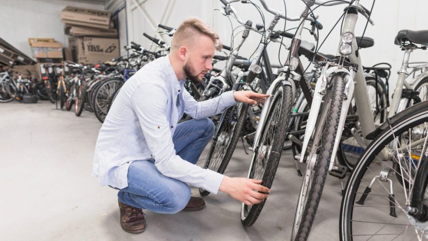 Man Inspecting Bike