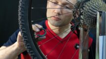 Mechanic Adjusting Bike Spokes