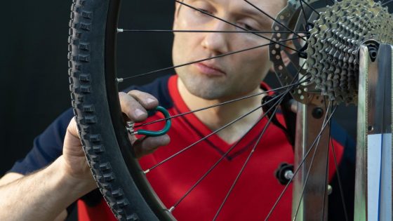 Mechanic Adjusting Bike Spokes
