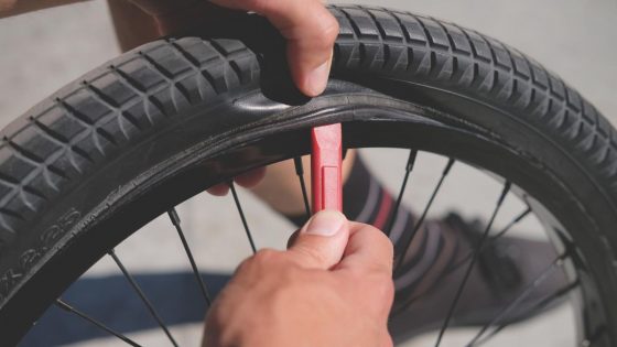 Mechanic Removes Bike Tire From Wheel