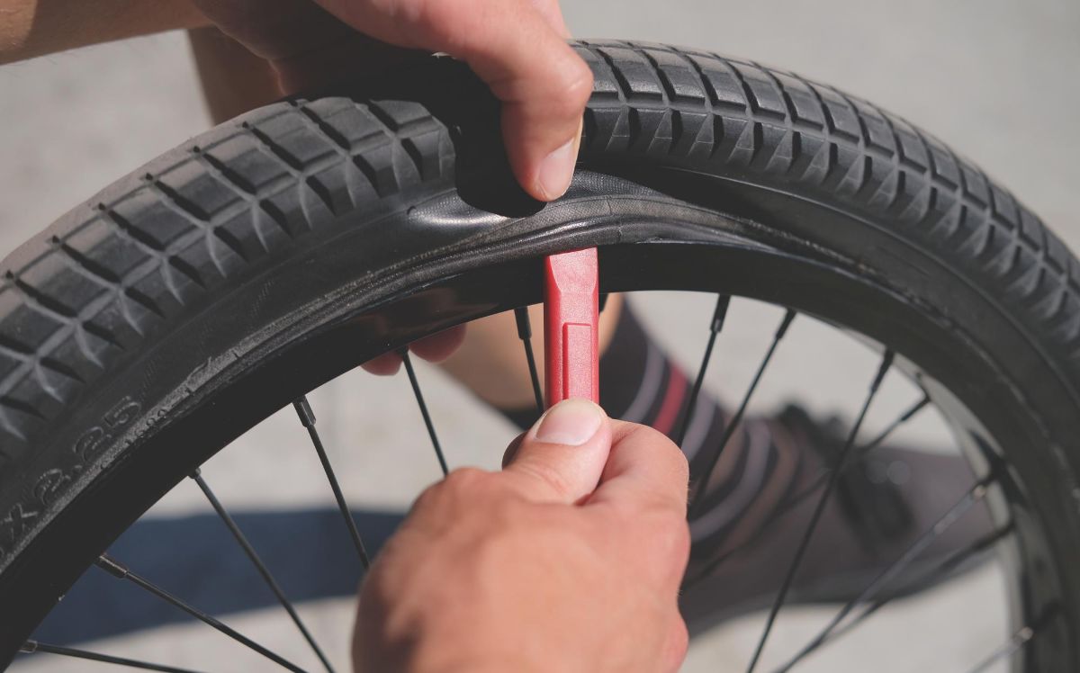 Mechanic Removes Bike Tire From Wheel