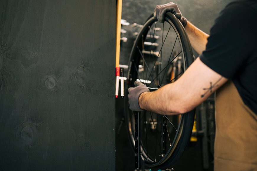 Person Inspecting Bicycle Tyre