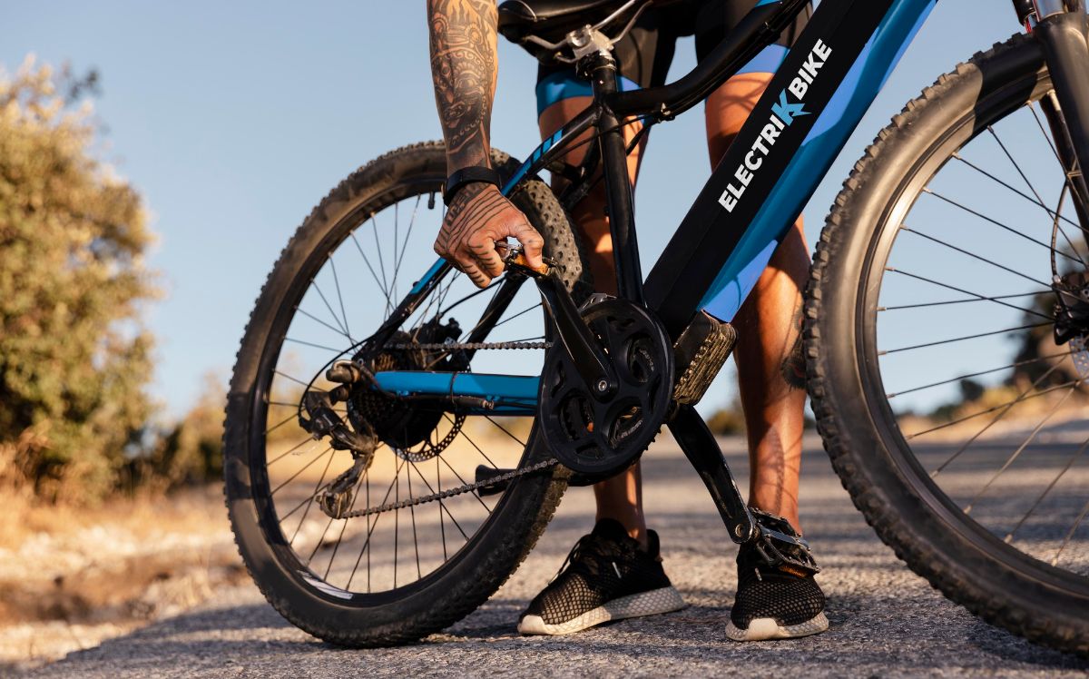 Cyclist Fixing The Bike Pedal