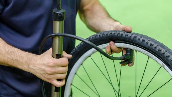 Cyclist Inflating Bike Tire