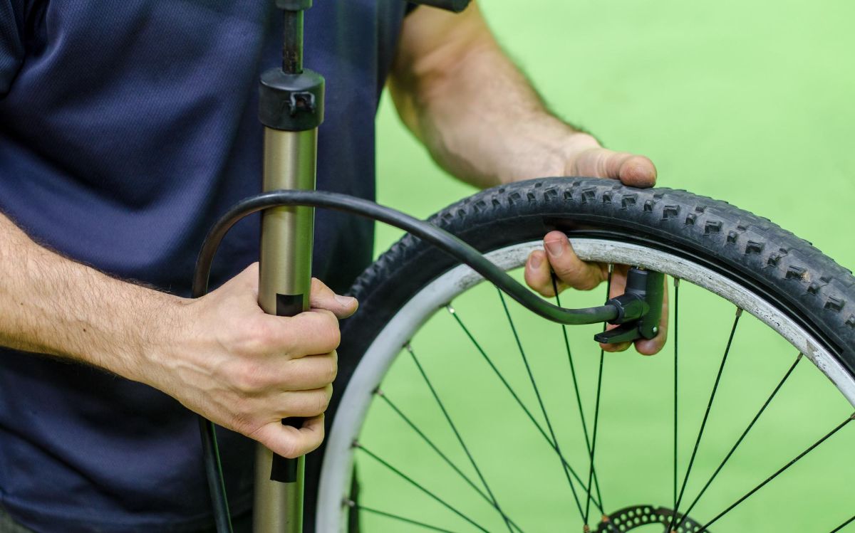 Cyclist Inflating Bike Tire