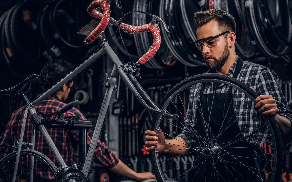 Mechanic Installing Replacing A Bike Tire