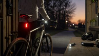 Cyclist checking front bike light runtime before an evening commute.